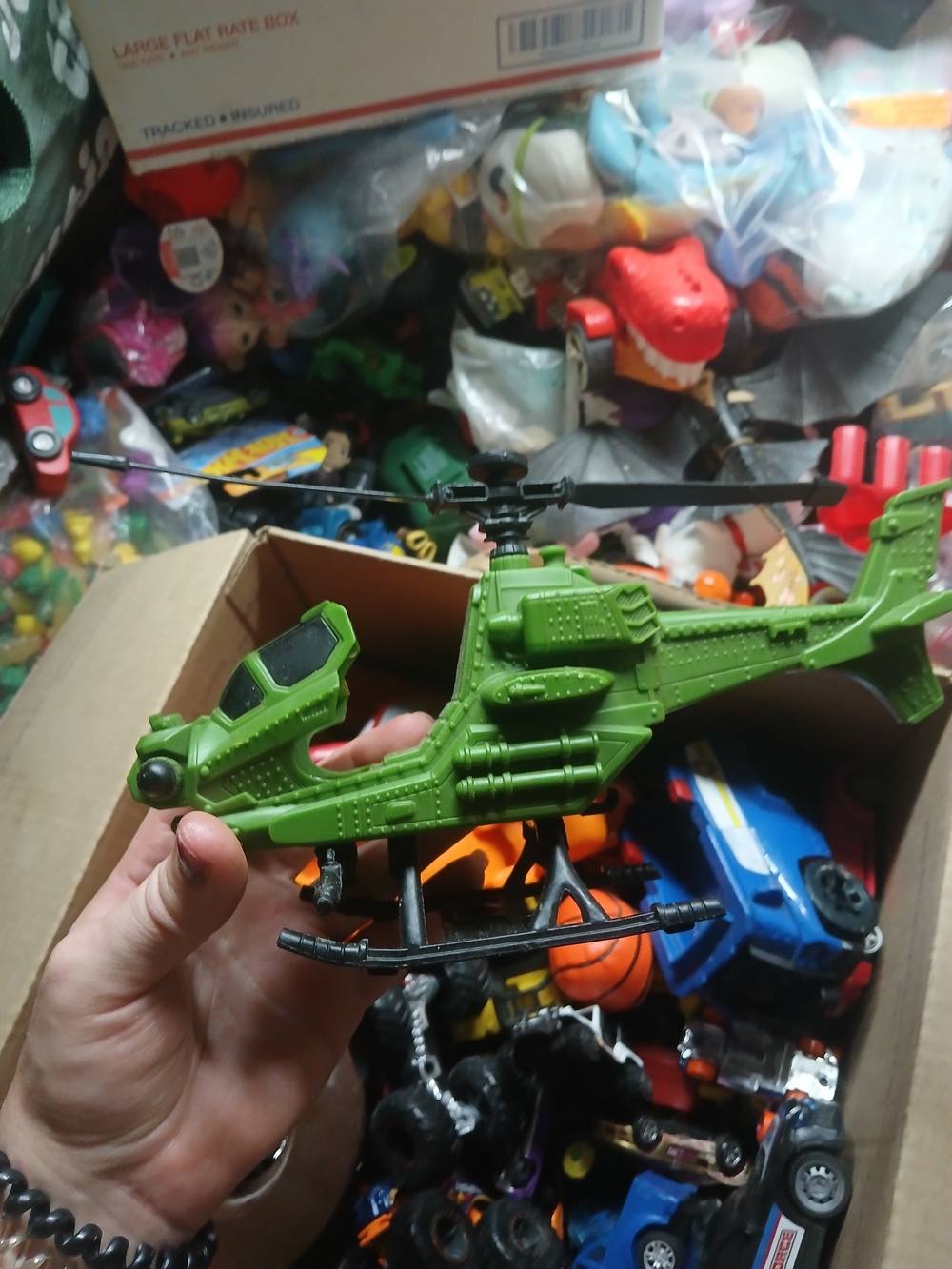 green military helicopter toy is identified as a True Heroes Sentinel 1 model